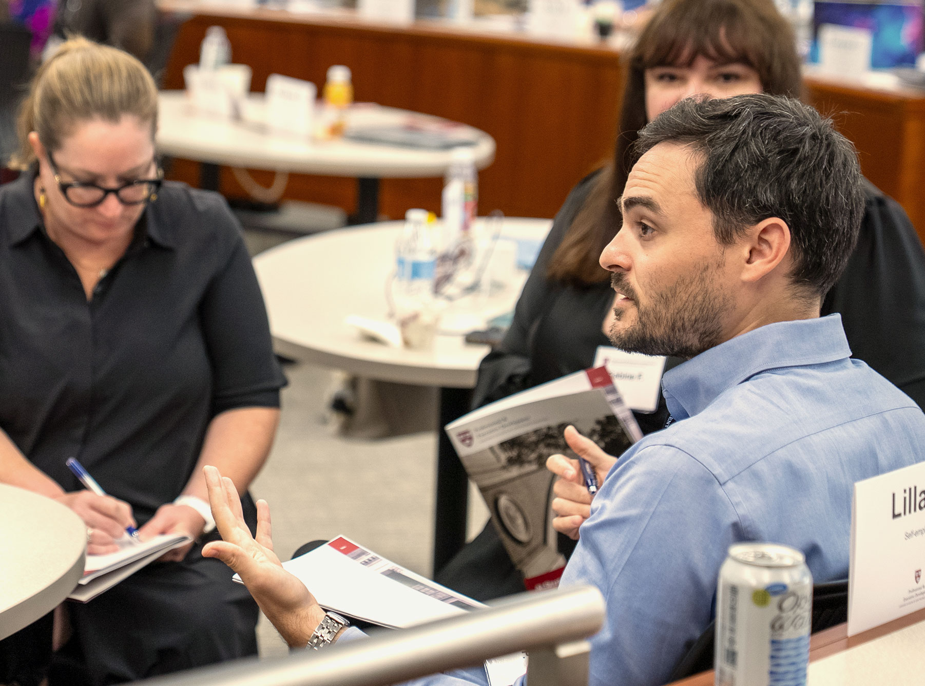 A group of Harvard Professional & Executive Development students work together in class.