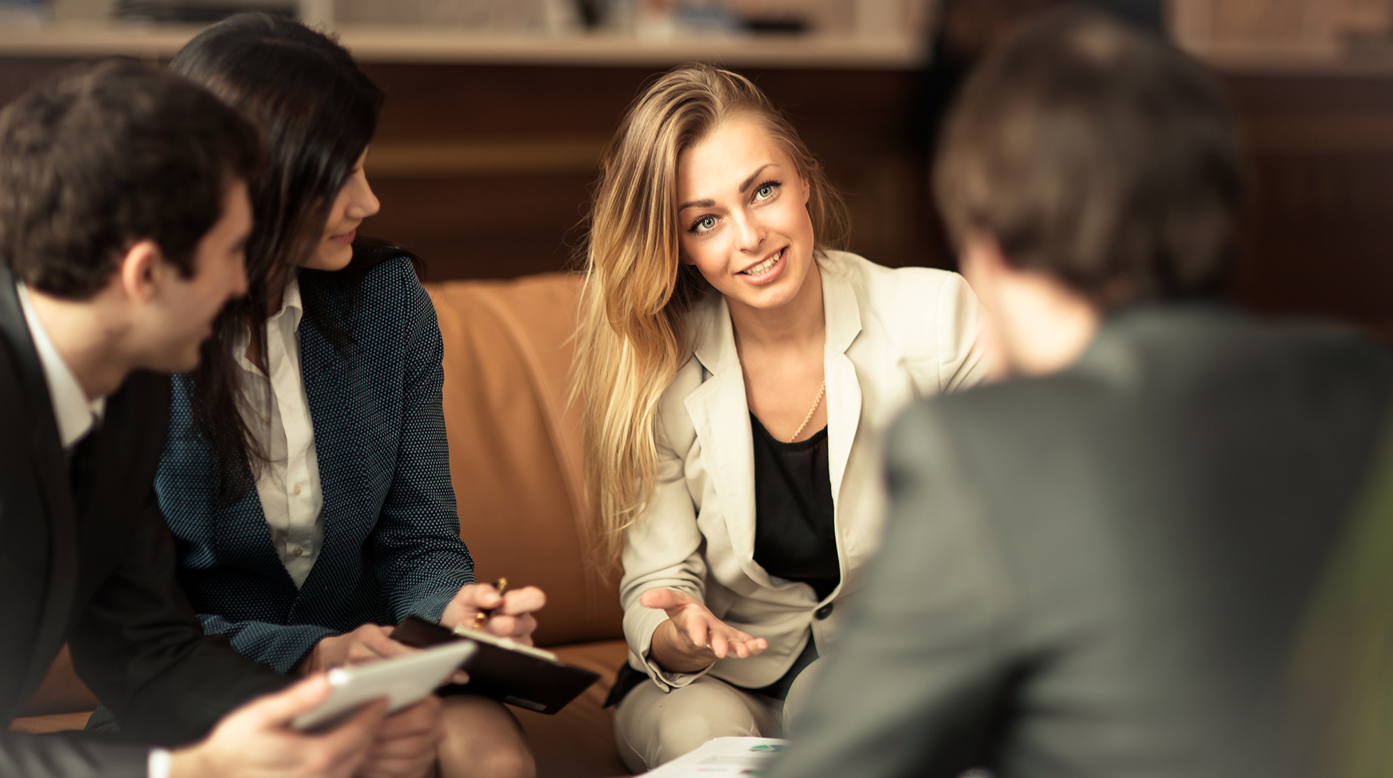 female negotiating with business people